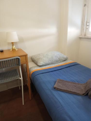 a bedroom with a bed and a desk with a pillow at Amoreiras Lisbon Apartments in Lisbon