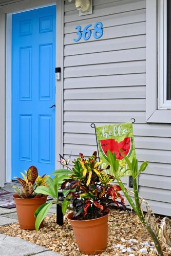 a house with a blue door and some plants at Beach House Retreat in Cape Canaveral