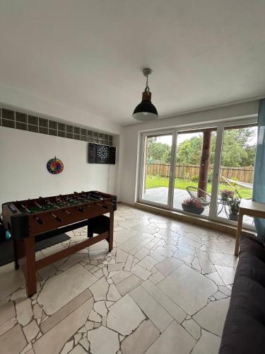 a living room with a pool table on a tile floor at Dwór pod Sosnami Kaszuby, sauna in Ostrzyce
