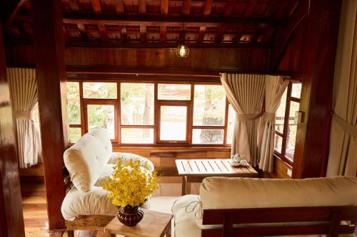 a living room with a couch and a table at Gỗ Home in Ðinh An (2)
