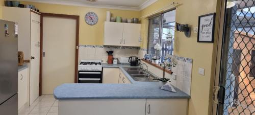 a kitchen with a sink and a counter top at Ocean Street Delight in Esperance