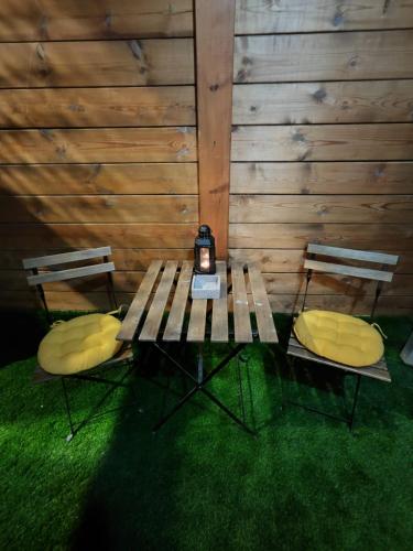 a picnic table with two chairs and a lamp on it at Michael's- A Lovely Studio Apartment in Eilat