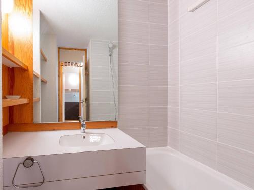 La salle de bains blanche est pourvue d'un lavabo et d'une baignoire. dans l'établissement Studio divisible, 4 pers, Parking souterrain, La Plagne - FR-1-353-25, à La Plagne