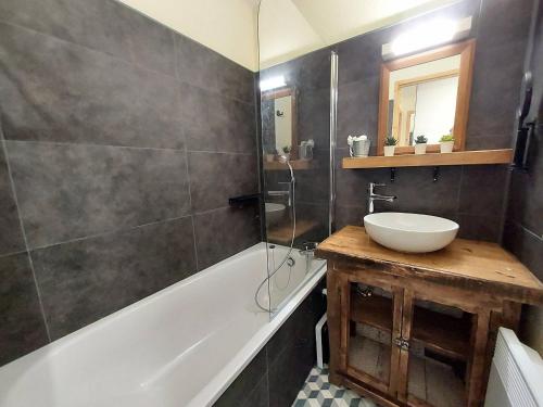 a bathroom with a sink and a bath tub at Appartement cosy 2 pièces à La Plagne, proche des pistes - FR-1-353-122 in La Plagne Tarentaise
