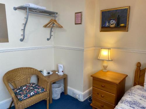 a bedroom with a bed and a table and a chair at The Laurels in Blackpool