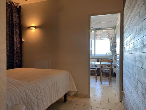 une chambre avec un lit et une salle à manger dans l'établissement Beau T1 rénové proche Parc Charles de Gaulle avec wifi - FR-1-553-275, à Balaruc-les-Bains