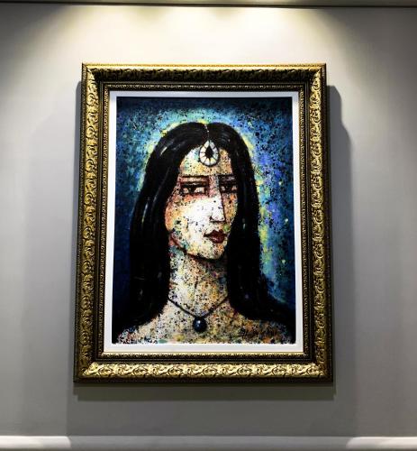 a painting of a woman on a wall at Regal Suite by StayMehman in Rawalpindi
