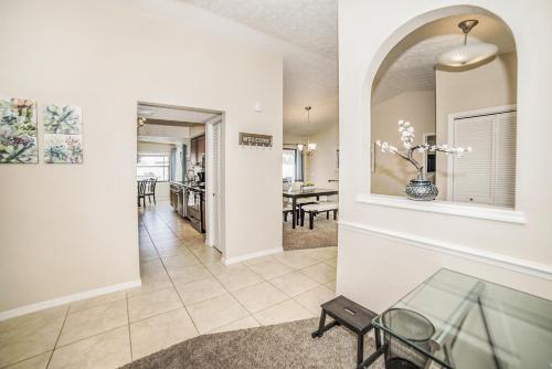 a living room with a glass table and a dining room at Zen Oasis - Royal Pool Paradise Near Tampa in Brandon