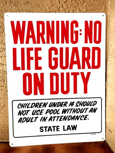 a no life guard sign on a wall at Zen Oasis - Royal Pool Paradise Near Tampa in Brandon