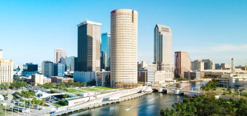 a city skyline with a river and skyscrapers at Zen Oasis - Royal Pool Paradise Near Tampa in Brandon