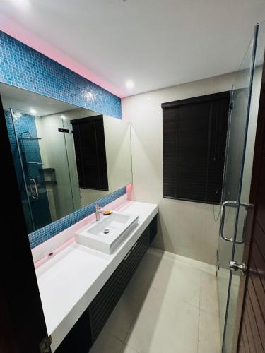 a bathroom with a sink and a mirror at Sunrise Villa 21 in Phuket Town
