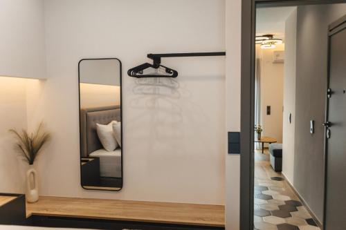 a mirror on a wall next to a room at Home Avenue in Alexandroupoli
