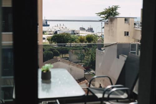 a balcony with a table and a view of the ocean at Home Avenue in Alexandroupoli