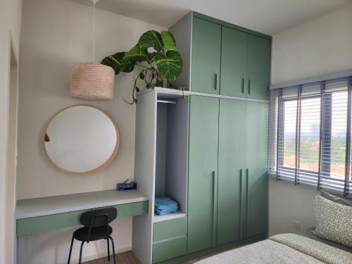 a bedroom with green cabinets and a mirror at LoveStayBangi - MyCanvas in Bandar Baru Bangi