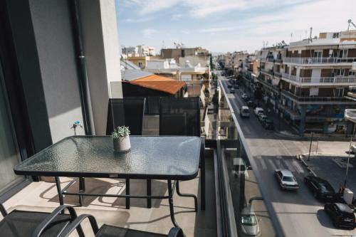 a table on a balcony with a view of a city at Home Avenue in Alexandroupoli