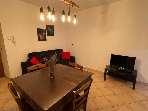 a living room with a table and a couch at Una Finestra sul passato in Andretta