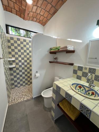 a bathroom with a toilet and a sink at Casa Barbara in Lo de Marcos