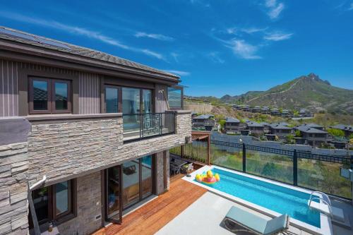 a house with a swimming pool and a balcony at Gubei Water Town Landscape Villa in Miyun