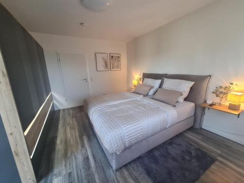 a bedroom with a large bed in a room at Premium Apartment am Rande des Pfälzer Waldes in Ramstein-Miesenbach