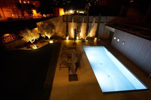an overhead view of a swimming pool at night at The home by the river in Bellano
