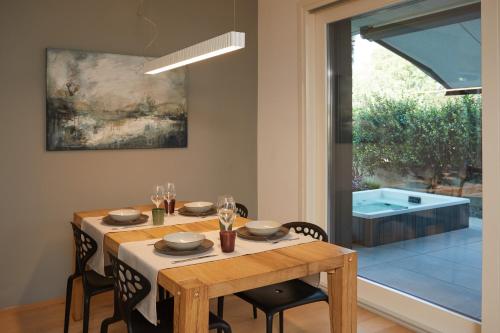 a dining room with a table and chairs and a window at The home by the river in Bellano