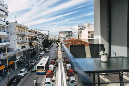 a view of a city street with cars and a bus at Home Avenue in Alexandroupoli