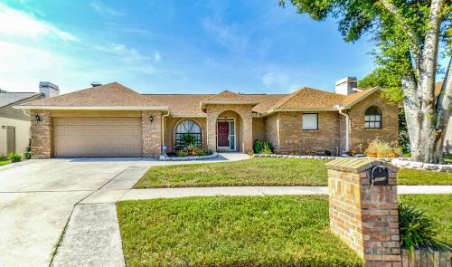 a large brick house with a garage at Zen Oasis - Royal Pool Paradise Near Tampa in Brandon