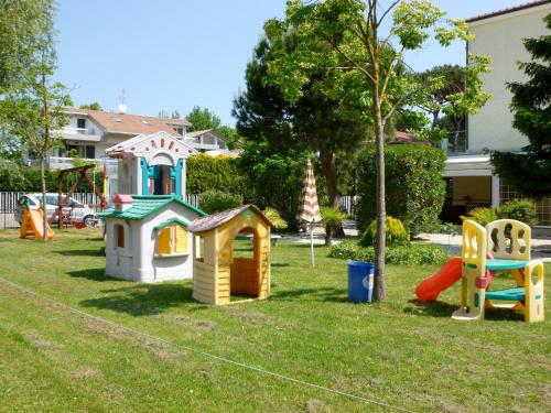 a group of childrens playground equipment in a yard at Villa Liliana in Cervia