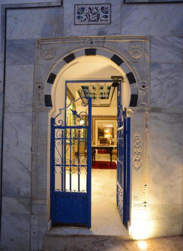 an entrance to a building with a blue door at Dar Essalem in Sidi Bou Saïd