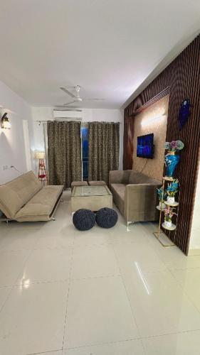 a living room with a couch and a table at Wanderers inn- beautiful hills view in Dehradun