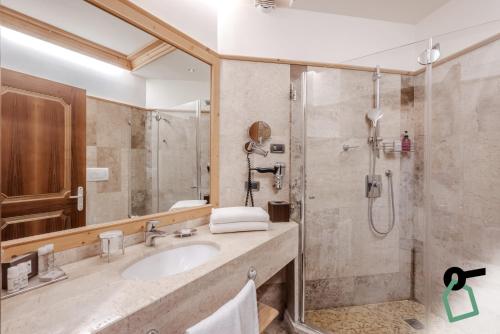 a bathroom with a sink and a shower at HOTIDAY Room Collection - Campiglio Pradalago in Madonna di Campiglio