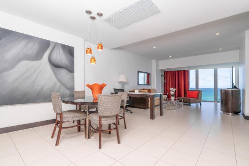 a living room with a dining room table and chairs at The Condado Plaza Hotel in San Juan