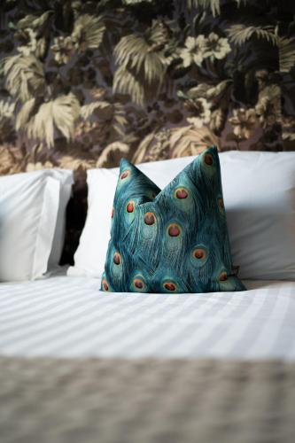 a blue pillow sitting on top of a bed at Bellinter House Hotel & Spa in Navan
