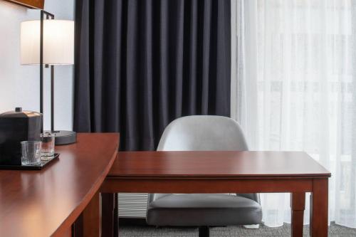 a desk with a chair in front of a window at Courtyard by Marriott Dulles Airport Herndon/Reston in Herndon