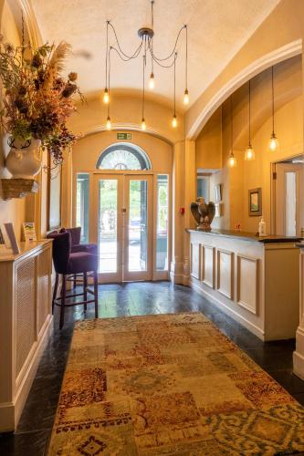 a large room with a kitchen and a dining room at The Falcondale at Lampeter in Lampeter