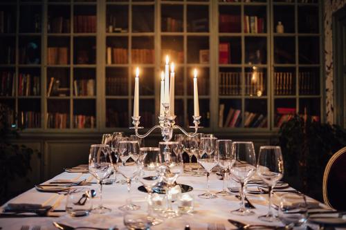 a long table with wine glasses and candles on it at Bellinter House Hotel & Spa in Navan