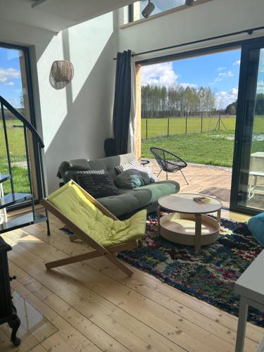 a living room with a couch and a table at Sielski domek w Starej Hucie in Stara Huta