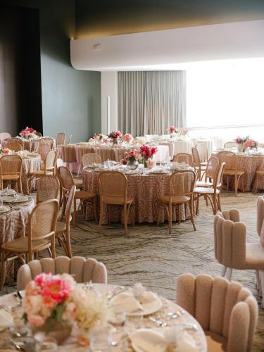 a room full of tables and chairs with flowers on them at Hilton Garden Inn San Juan Condado in San Juan