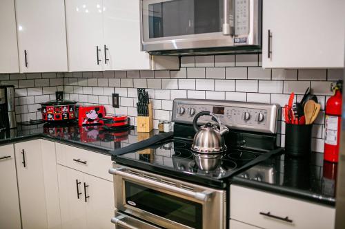 a kitchen with a stove with a tea kettle on it at Thematic House with Private PoolSpaGame Room in Loughman
