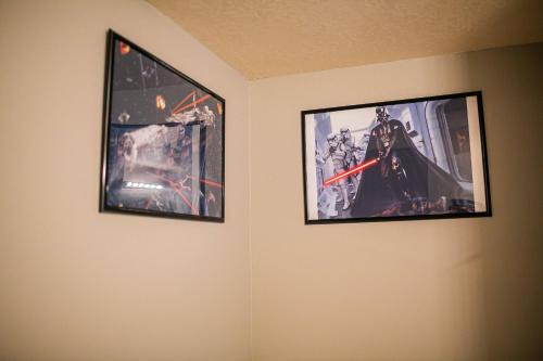 two pictures hanging on a wall in a room at Thematic House with Private PoolSpaGame Room in Loughman