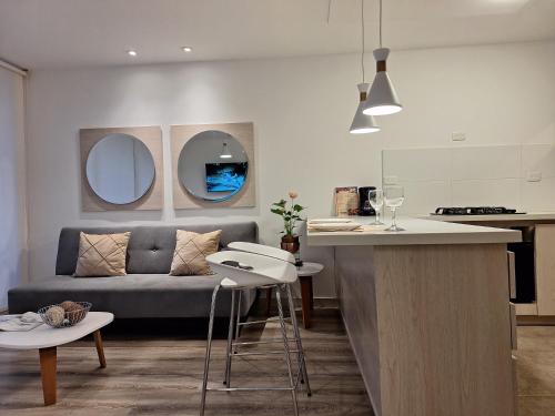 a kitchen and living room with a couch and a table at Apartamento Exclusivo Manizales in Manizales