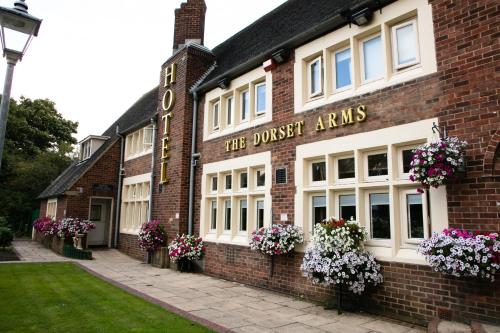a brick building with a sign that reads the dresser arms at DORSET ARMS HOTEL in Newcastle upon Tyne