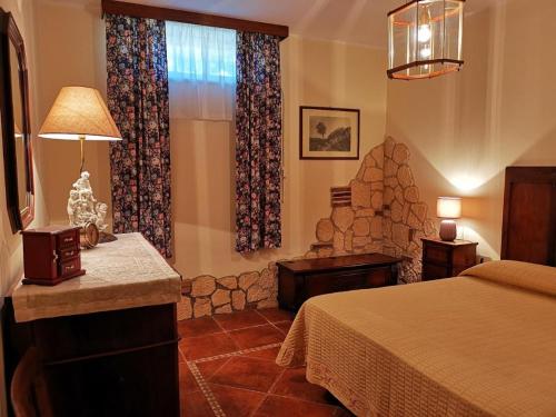 a hotel room with a bed and a stone fireplace at Villa Montesegnale in Bolsena