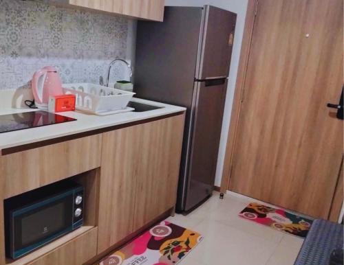 a small kitchen with a refrigerator and a sink at La Habana HuaHin by Pikul in Khao Tao