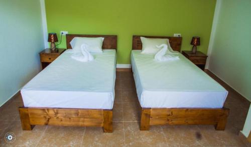 two beds sitting next to each other in a room at Pousada Green Place in Ribeira Grande