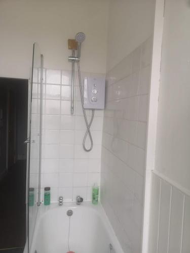 a bathroom with a shower and a shower head at Eagles Land in Edinburgh