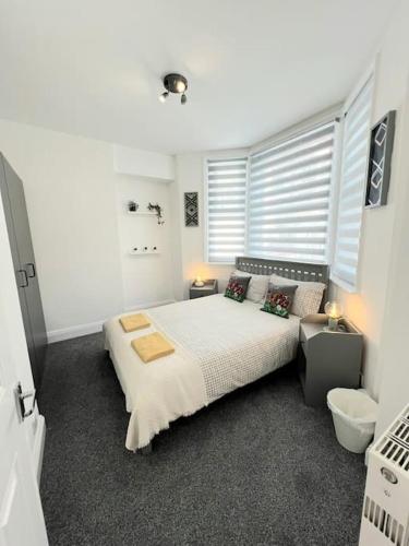a bedroom with a large bed and a window at Cosy Central 2 En-suite Bedrooms Apartment in Hastings