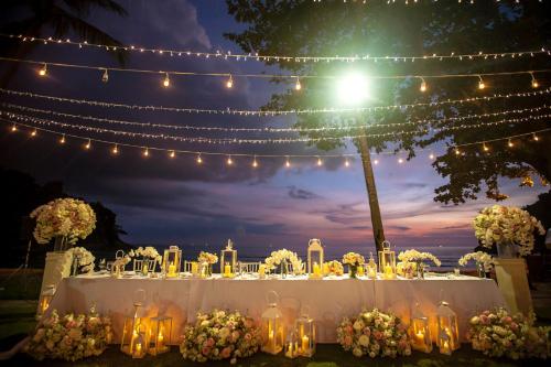 a wedding table with lights and flowers and lights at Phuket Marriott Resort & Spa, Merlin Beach in Patong Beach