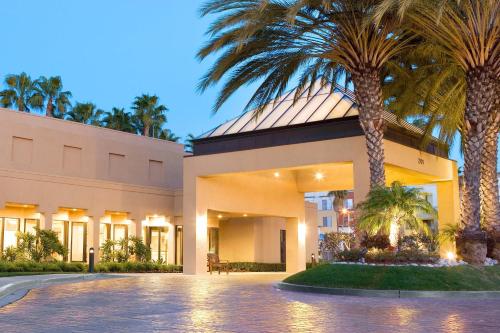 a building with palm trees in front of it at Courtyard Irvine John Wayne Airport/Orange County in Irvine