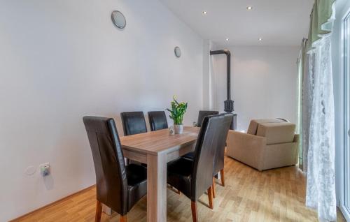 a dining room with a wooden table and black chairs at 3 Bedroom Cozy Home In Zminj in Žminj